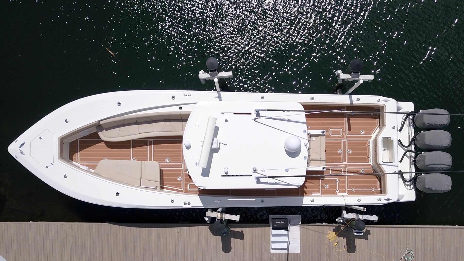 A detailed overhead view of a professional boat flooring installation showing perfectly aligned