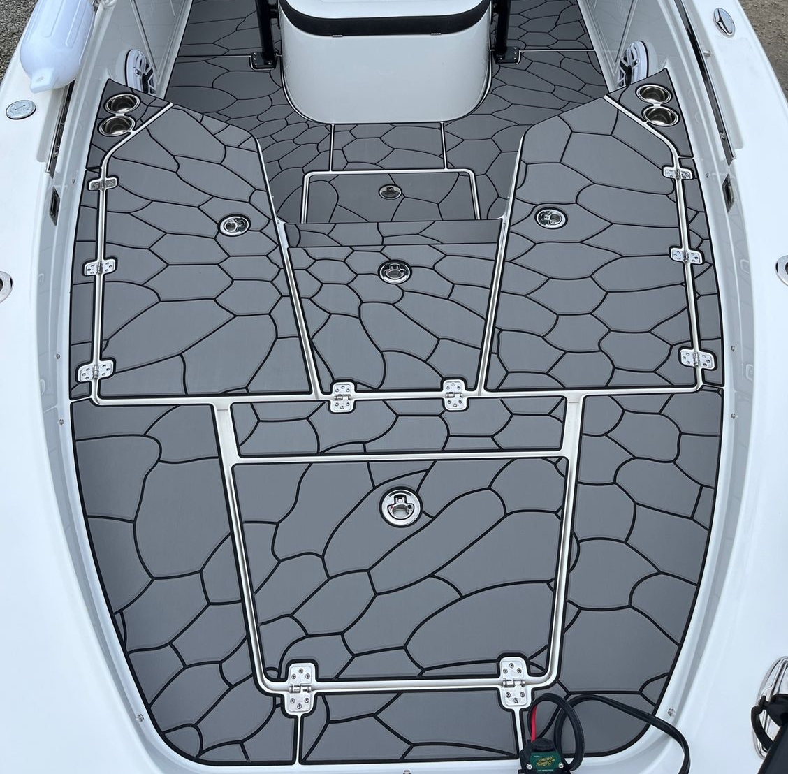 Overhead aerial view of a white sport fishing vessel's deck showing a centered captain's console