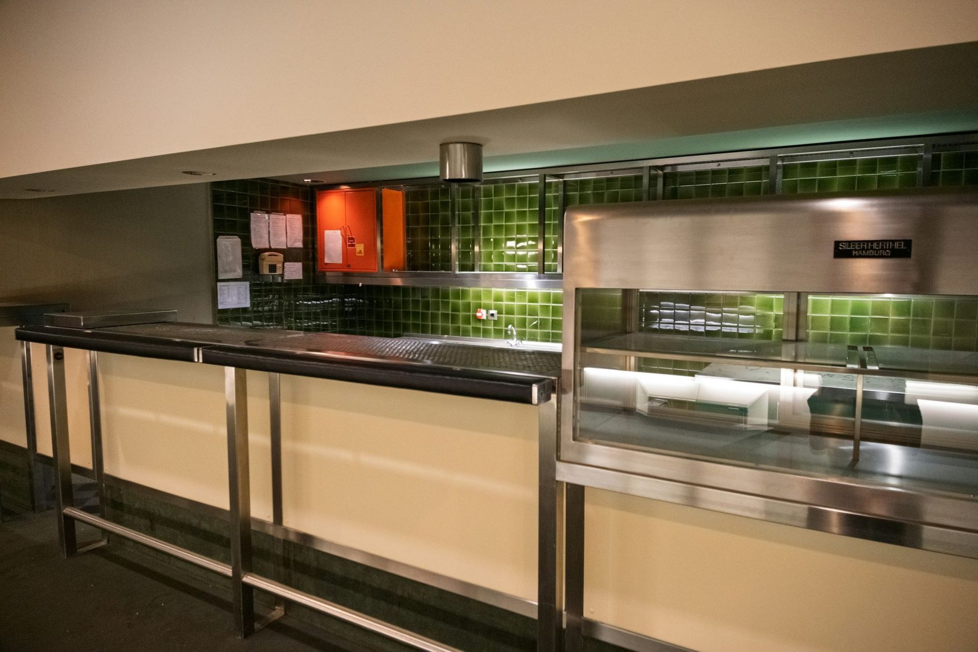 A clean stainless serving line and prep counter