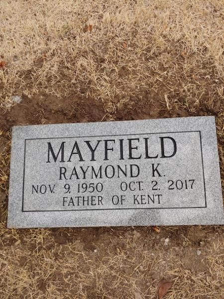 Gravestone plaque reading “MAYFIELD Raymond K. Nov. 9, 1950 – Oct. 2, 2017, Father of Kent”