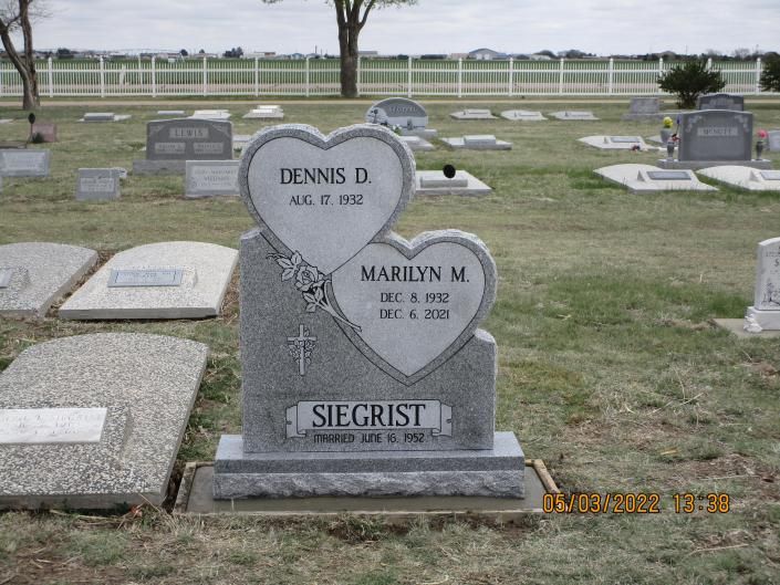 Heart-shaped double gravestone in a cemetery with names Dennis D. and Marwyn M. Siegrist.