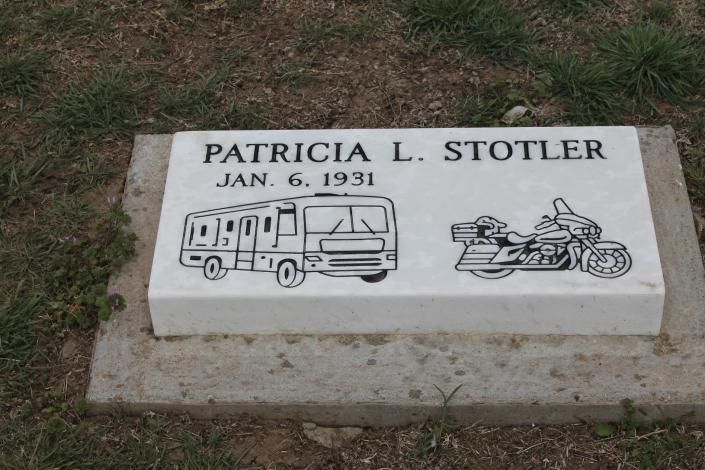 Gravestone for Patricia L. Stotler, Jan. 6, 1951, with a camper and motorcycle engraving.