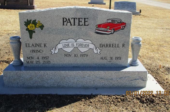PATEE family gravestone with flowers and a red car engraving in a cemetery