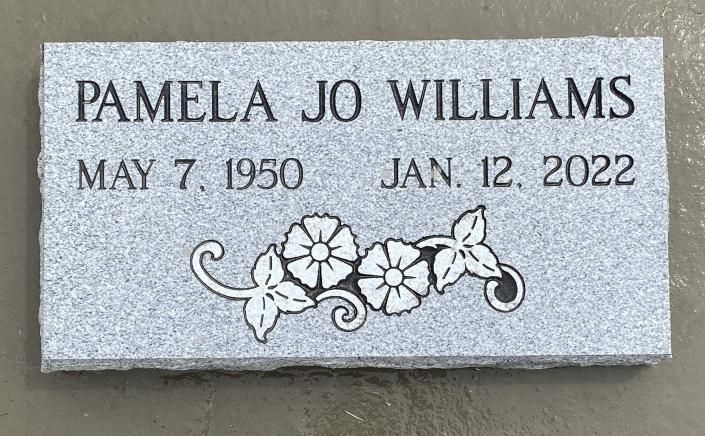 Gravestone plaque with “PAMELA JO WILLIAMS,” dates May 7, 1950 and Jan. 12, 2022, and floral engraving