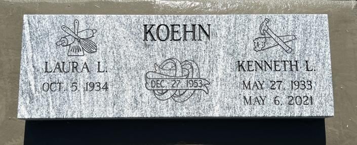Gray granite memorial plaque engraved “Koehn” with Laura L. and Kenneth L. names and dates