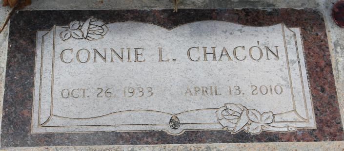 Gravestone engraved “Connie L. Chacon” with dates Oct. 26, 1933 and Apr. 13, 2010, framed by flowers