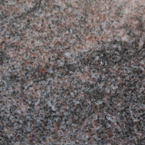 Close-up of a speckled pink, gray, and black stone or granite surface