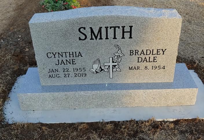 Gray Smith family gravestone with engraved names and dates in a cemetery