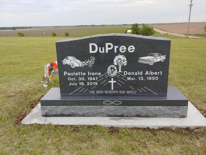 Black DuPree gravestone on a grassy plot in an open cemetery field.