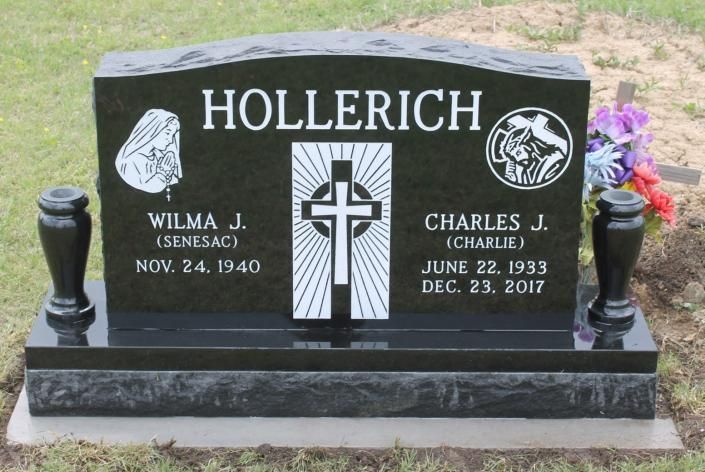 Black granite Hollerich family gravestone with white lettering and cross, set on grass.
