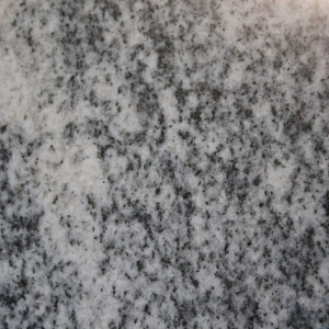 Close-up of gray and black speckled stone surface with a mottled texture