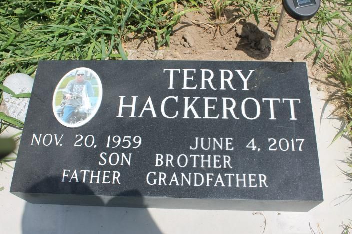 Gravestone for Terry Hackerott with dates Nov. 20, 1959 and June 4, 2017, on grass.