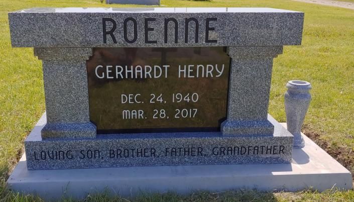 Stone gravestone for Gerhardt Henry with engraved dates and family names in a cemetery setting