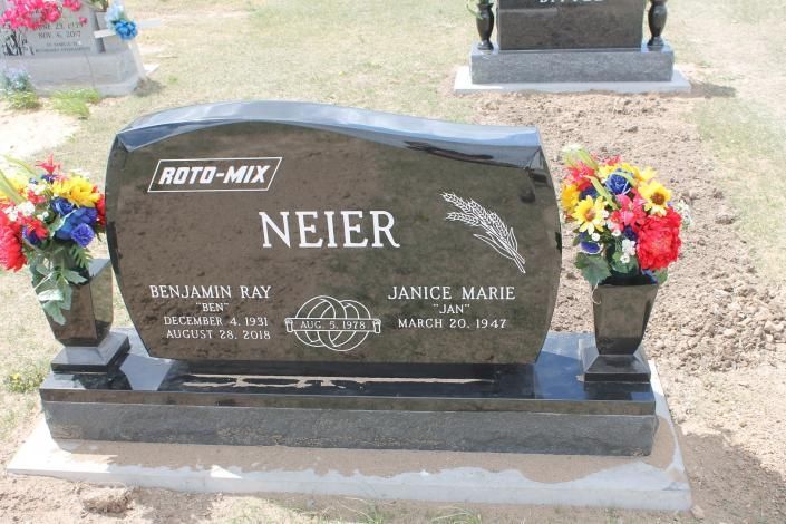 Black polished gravestone with the name “NEIER” and engraved family details in a cemetery