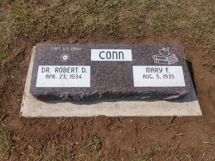 Grave marker with two name plaques, Robert D. and Mary I., set in dirt and grass.