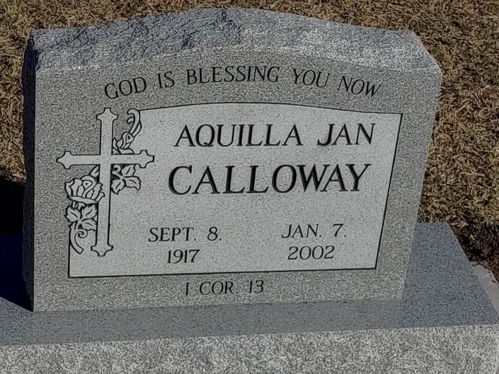 Gray gravestone engraved “AQUILLA JAN CALLOWAY” with cross and dates Sept. 8, 1917–Jan. 7, 2002.