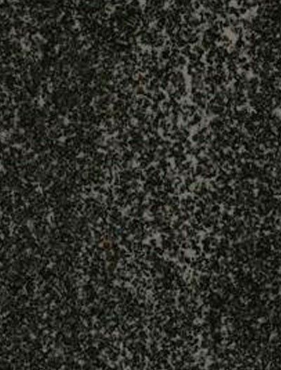 Close-up of dark speckled stone or granite surface with gray and white flecks
