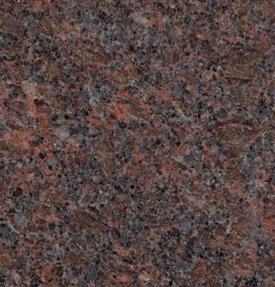 Close-up of a speckled red, gray, and black granite surface.