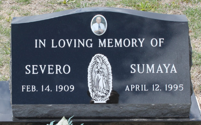 Black memorial gravestone with a Virgin Mary relief and the names Severo and Sumaya.