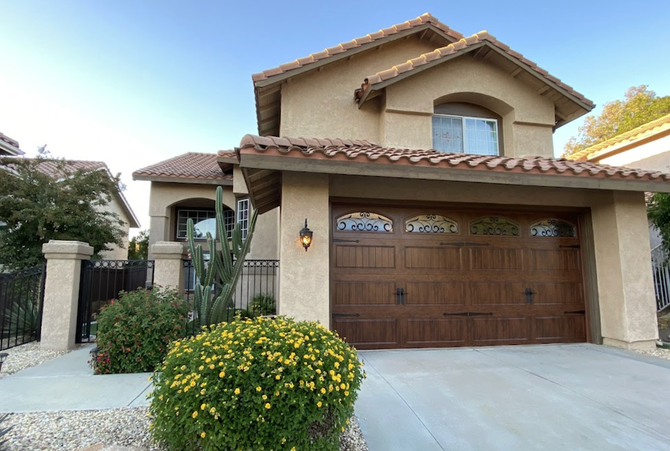 A Large House with A Large Wooden Garage Door