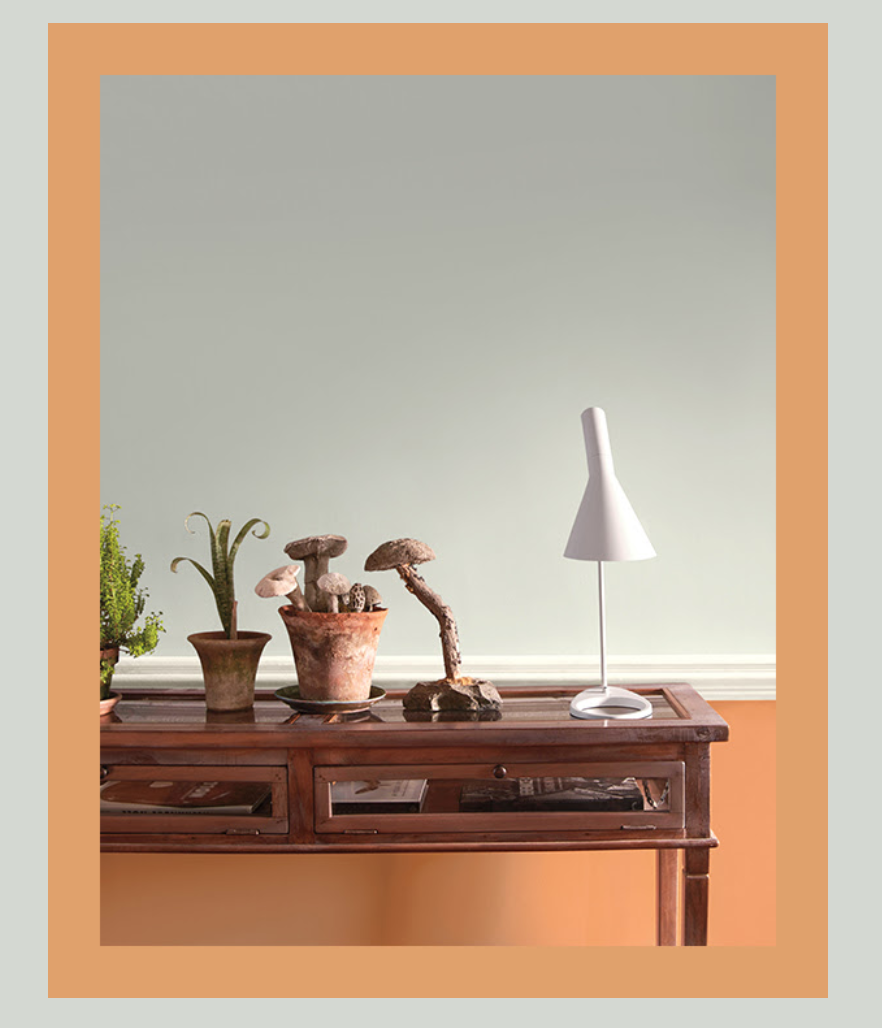 picture of a desk against a peach colored wall