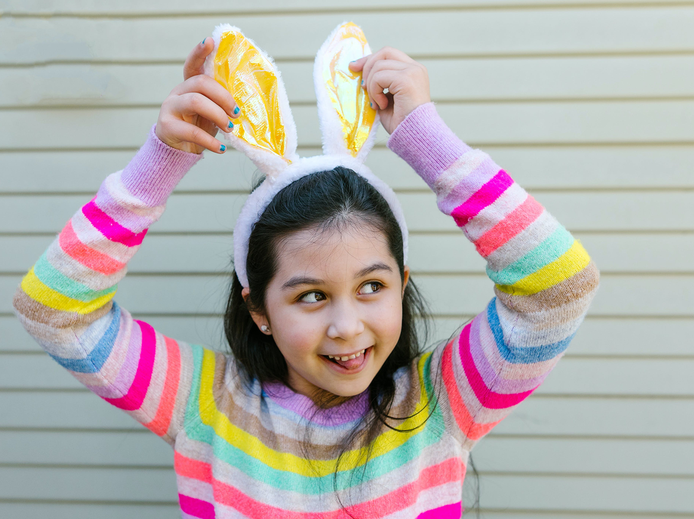 Young girl outside caravan wearing easter bunny ears