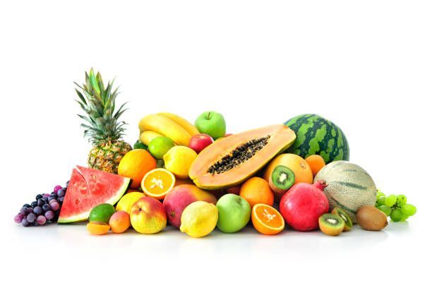 A pile of different types of fruit on a white background