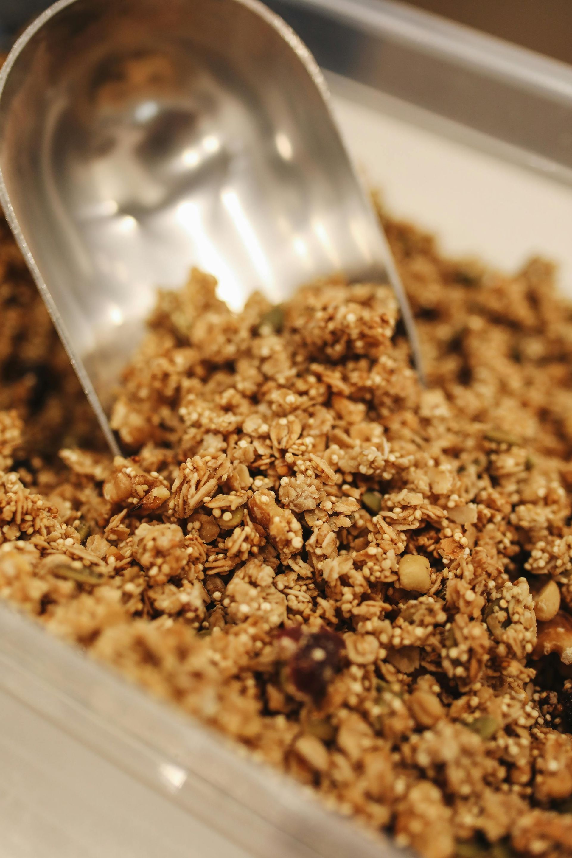 A close up of a spoon in a bowl of granola