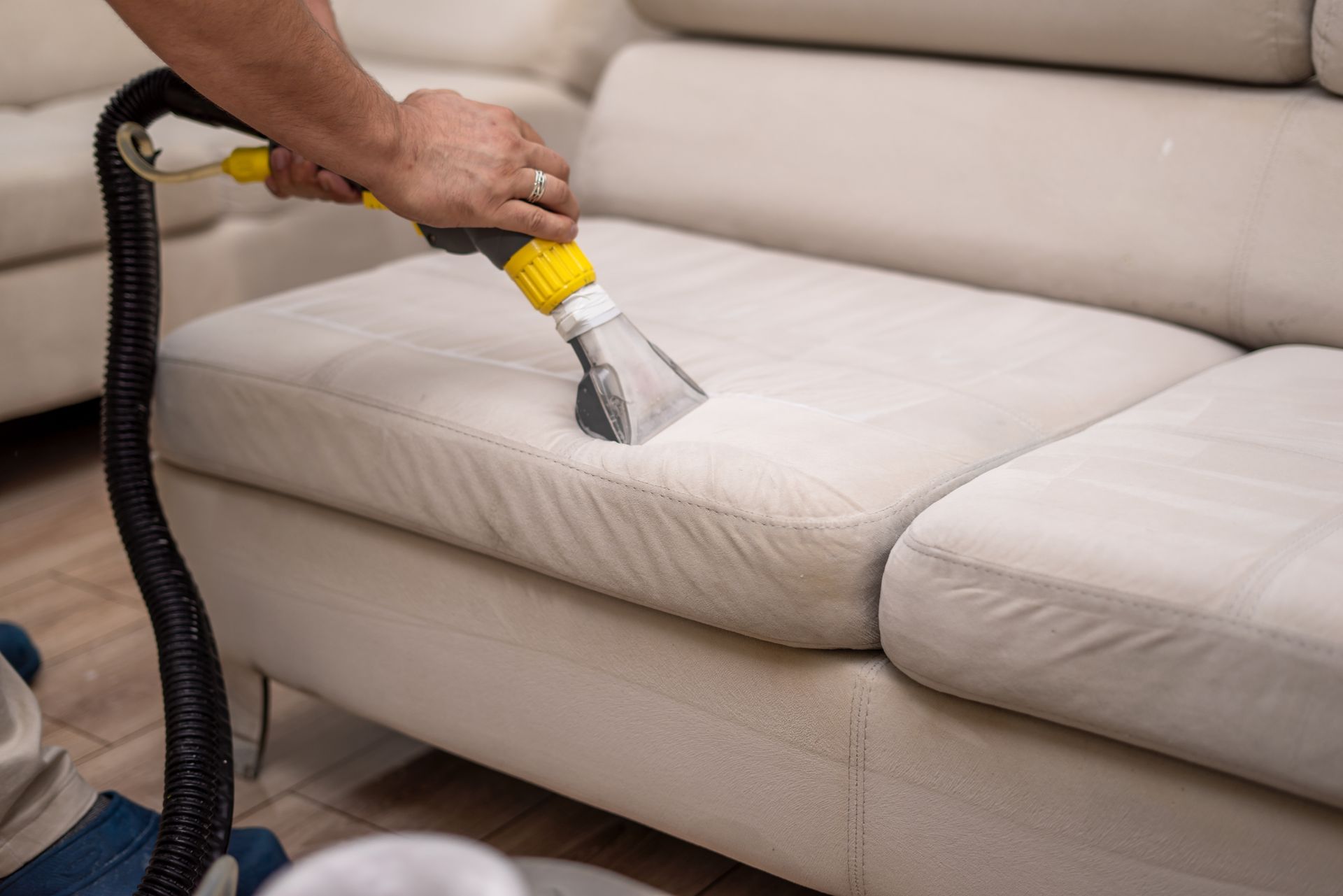 Dirty sofa being cleaned showcasing professional upholstery cleaning with a sofa washer. Dirty sofa being cleaned showcasing professional upholstery cleaning with a sofa washer.