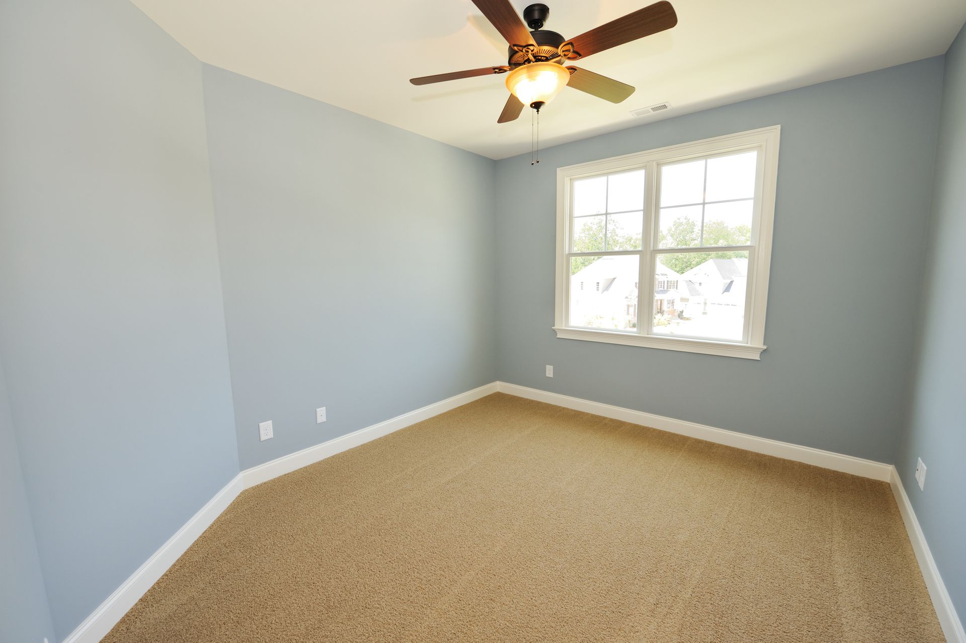 An empty room with a ceiling fan and a window - Wivenhoe, TAS - Summers Floors Pty Ltd