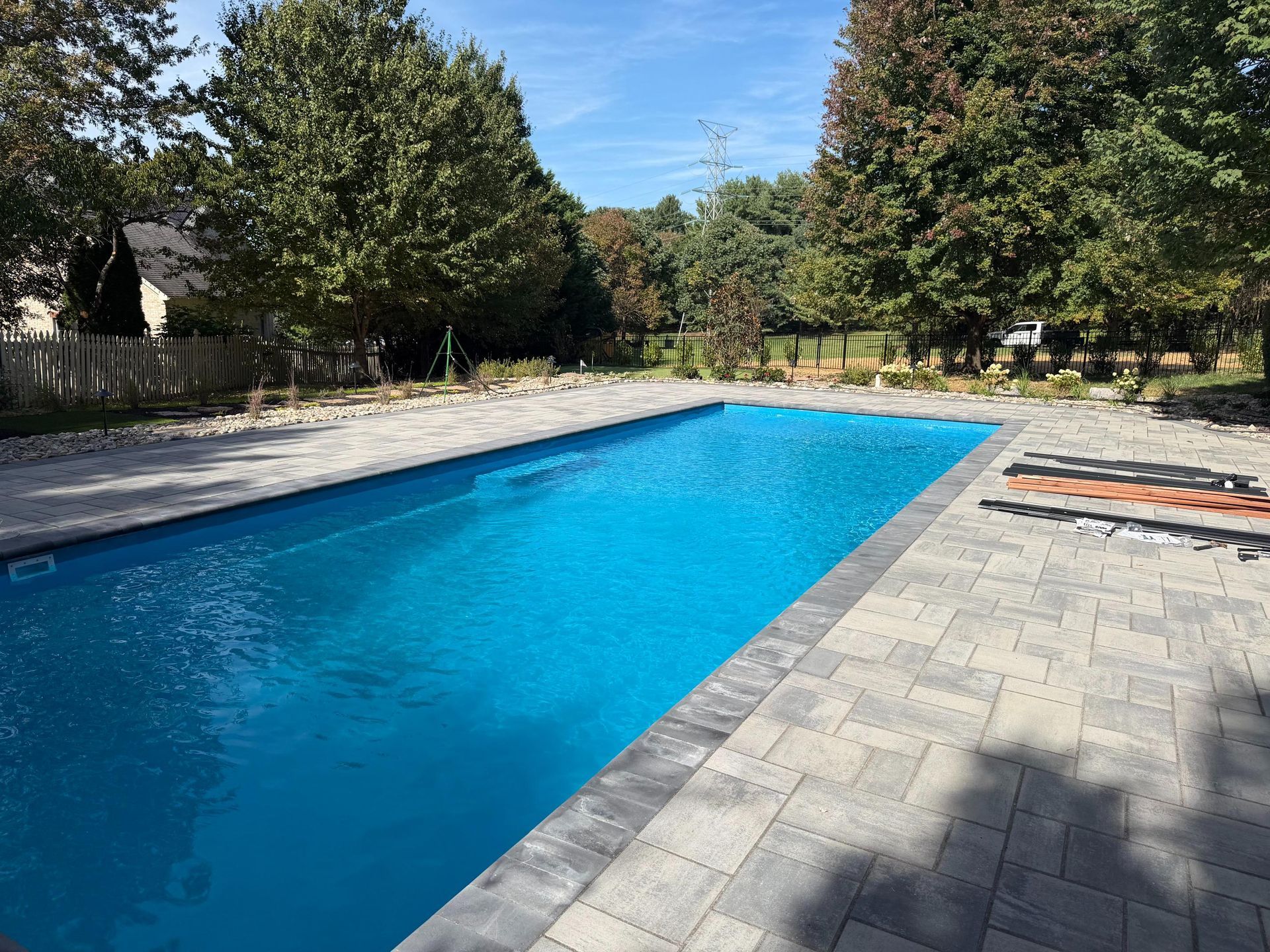 Rectangular swimming pool with full paver patio surround