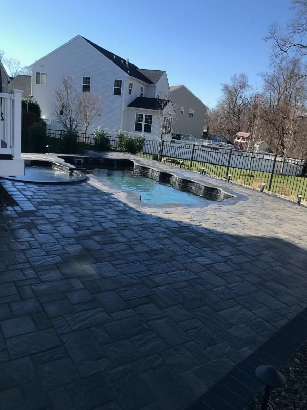 Swimming pool with raised spa and sheer descent water features