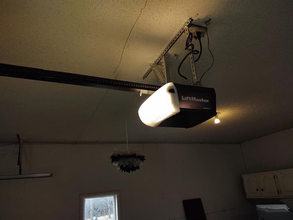 A garage door opener is hanging from the ceiling