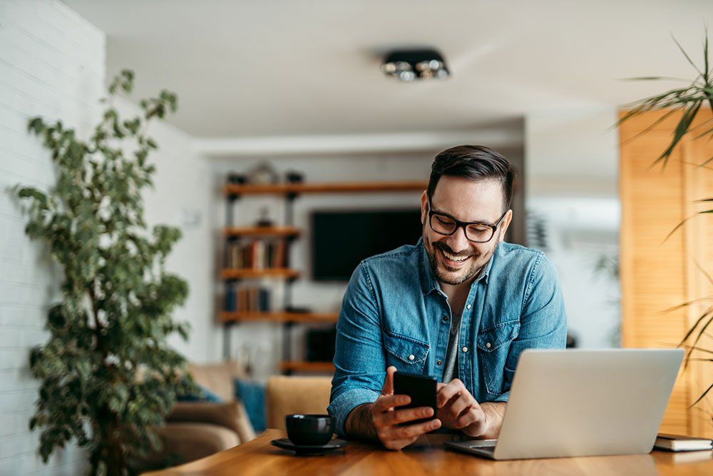 Man Holding a Phone — Dayton, OH — South Dayton Properties LLC