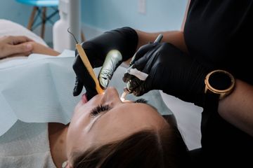 Dentist working on a patient's teeth. Dental tools, black gloves, open mouth, dental chair.
Harbour Grace Dental Hygiene