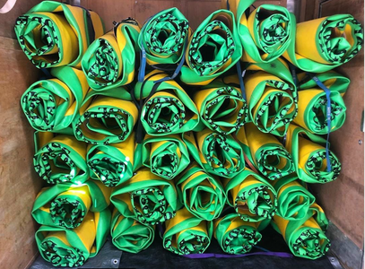 A box filled with yellow and green rolls of paper