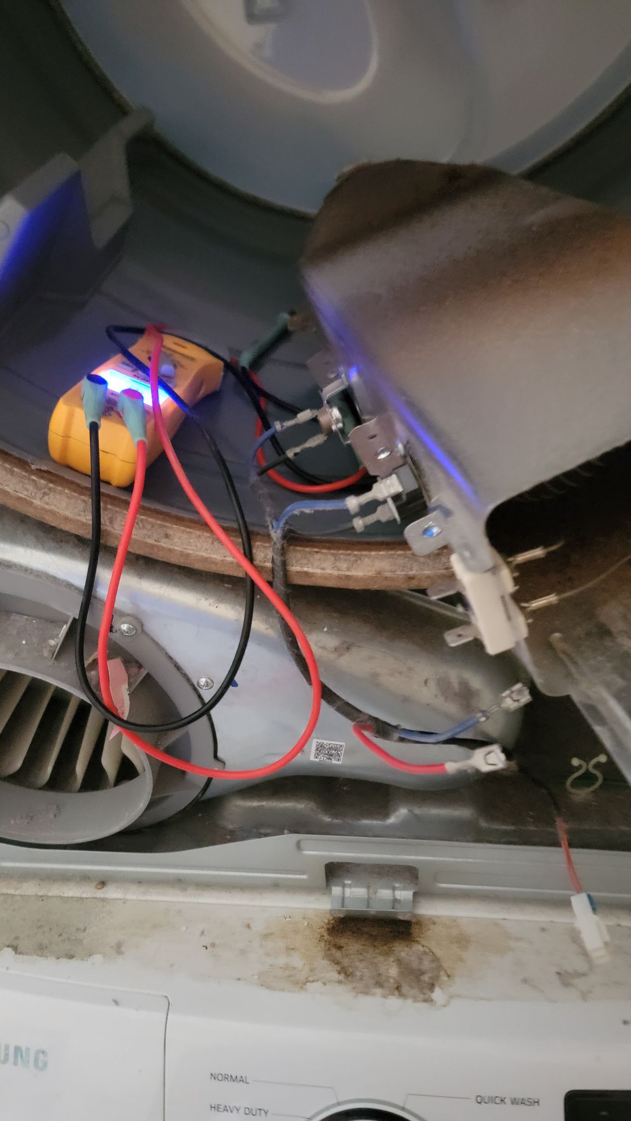 A close up of a washer and dryer with wires connected to it