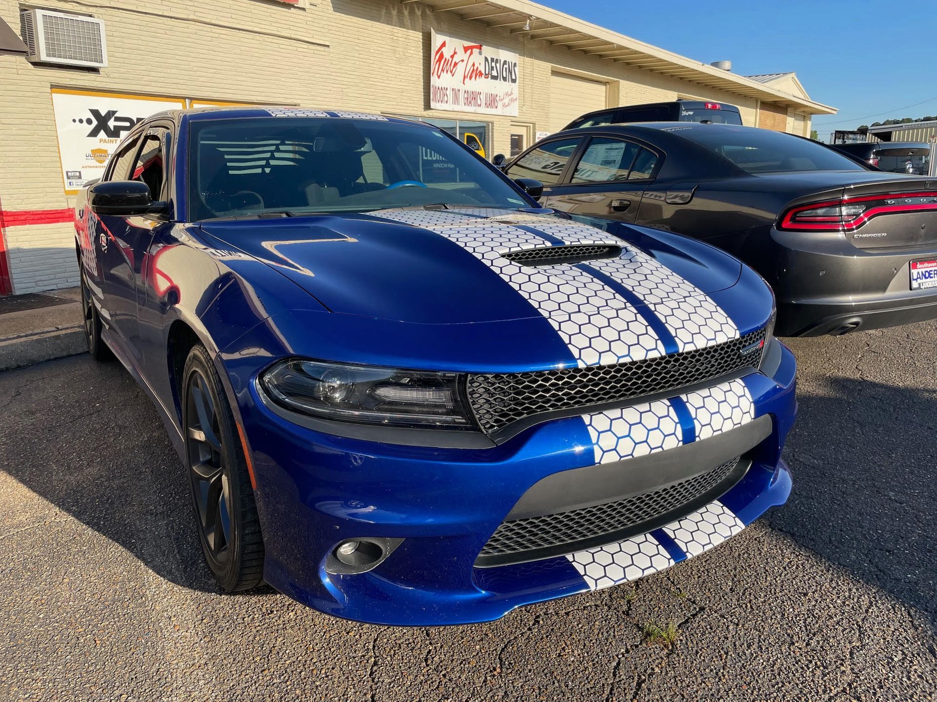 Dodge Charger with a honeycomb-pattern vinyl finish and window tint installed at Auto Trim Designs & Tint in Pearl, Mississippi.