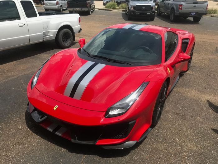 Red Ferrari Pista with racing stripe finished in Xpel paint protection film.