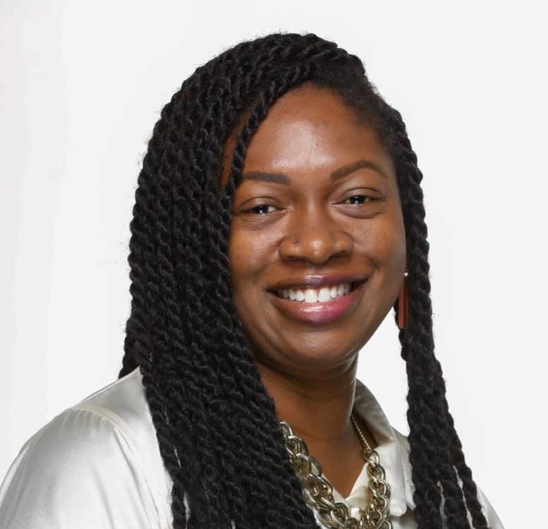 Portrait of a smiling woman with long braided hair on a white background