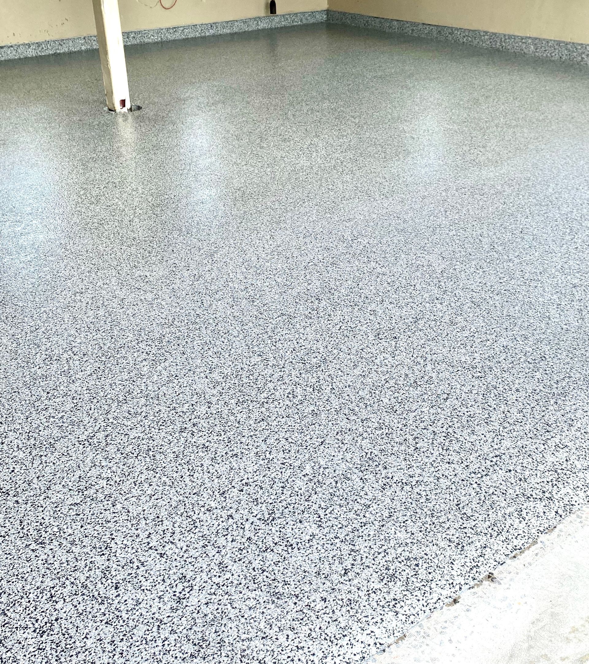 Two workers apply glossy blue floor coating in a white room