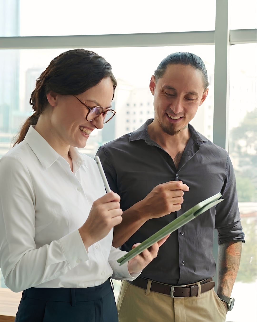 Two diverse business professionals collaborating on a digital development plan, representing Plan and Grow’s collaborative NDIS registration pathway for non-registered providers in Perth.