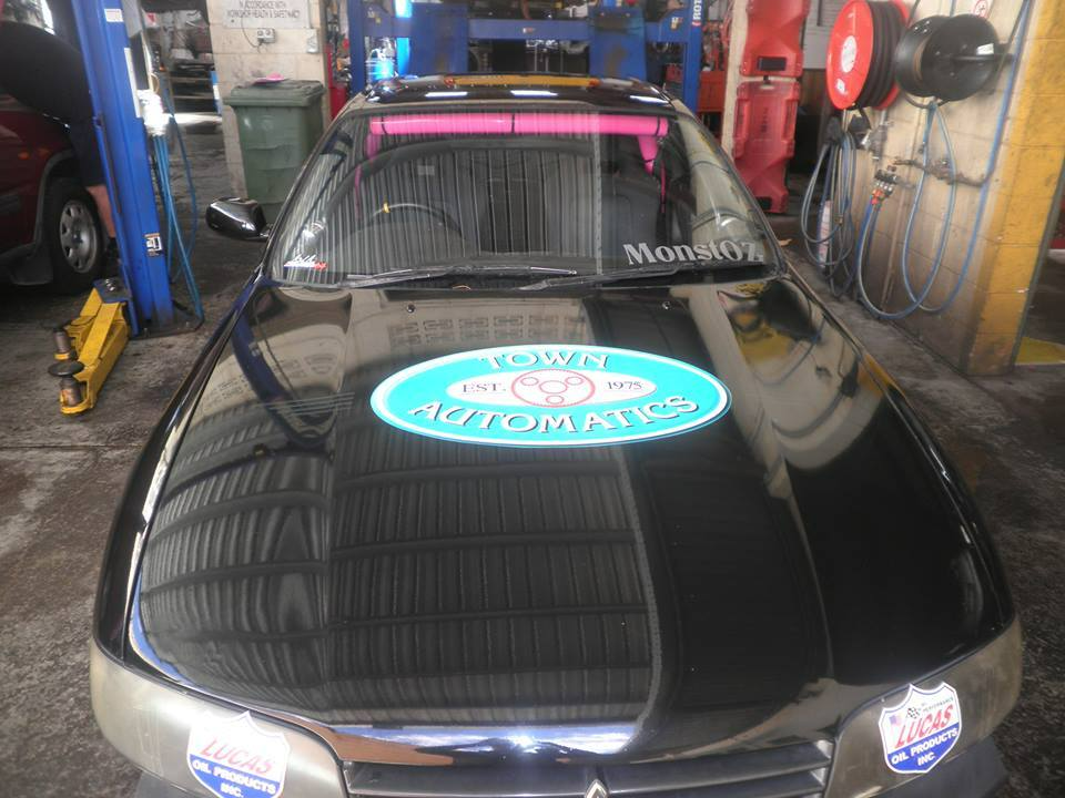 A Black car with a Sticker on the Hood that says ' Town automatics' — Town Automatics 4WD & Mechanical in South Townsville, QLD