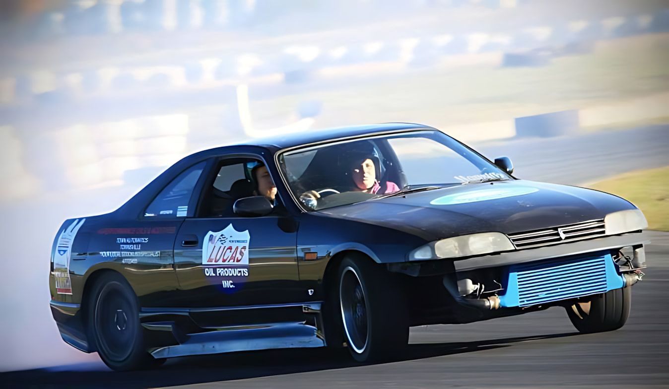 A Black Car Is Drifting On A Track — Town Automatics 4WD & Mechanical in South Townsville, QLD