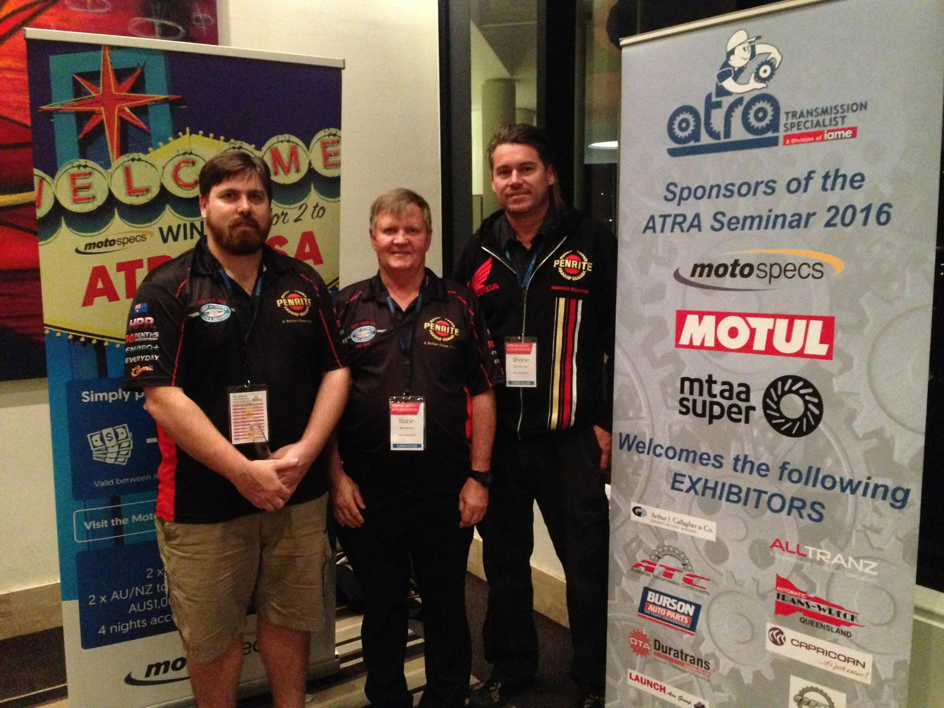 Three Men Standing In Front Of A Sign That Says Motul — Town Automatics 4WD & Mechanical in South Townsville, QLD