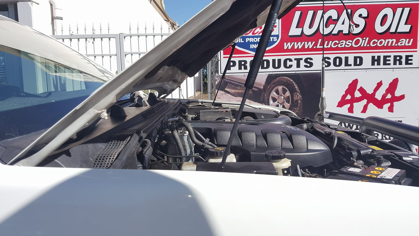 A White Car With The Hood Open Is Parked In Front Of A Lucas Oil Sign β Town Automatics 4WD & Mechanical in South Townsville, QLD