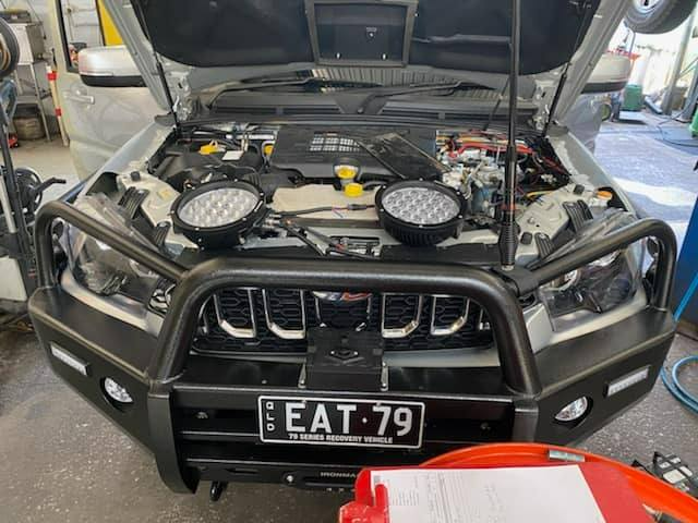 A Car With The Hood Up And A License Plate That Says EAT 79 — Town Automatics 4WD & Mechanical in South Townsville, QLD