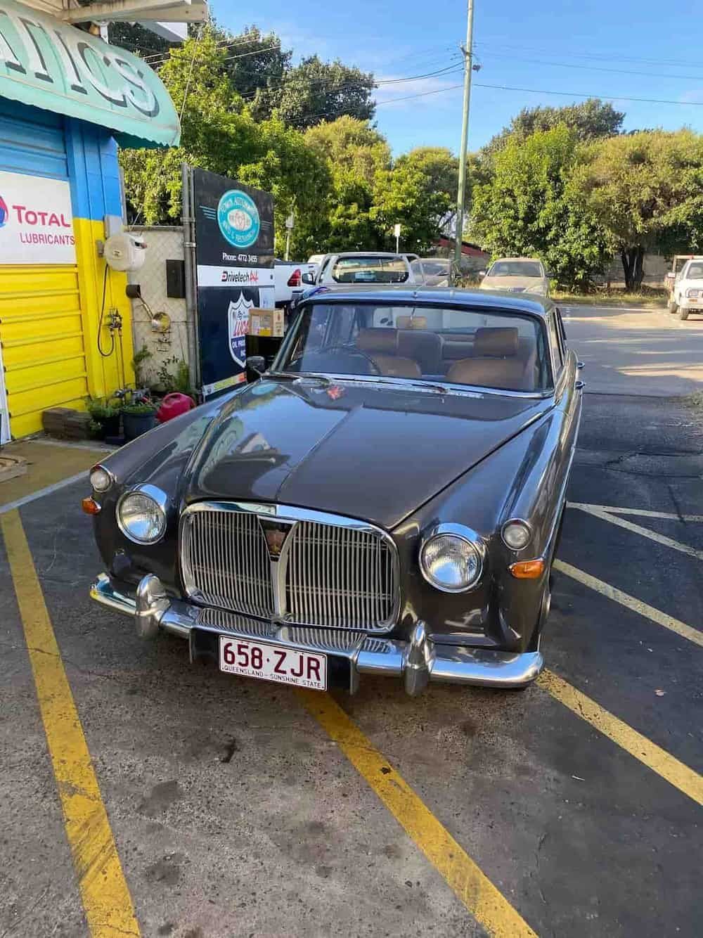 A Black Car Is Parked In A Parking Lot Next To A Yellow Line — Town Automatics 4WD & Mechanical in South Townsville, QLD