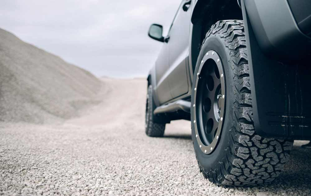 A Close Up Of A Truck's Tire On A Gravel Road — Town Automatics 4WD & Mechanical in South Townsville, QLD