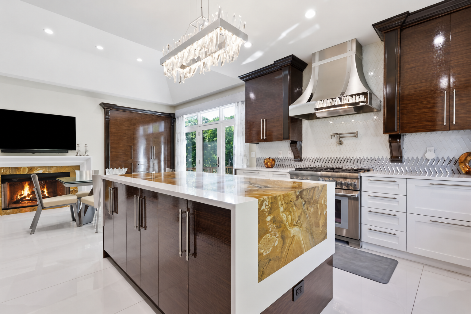 Bright modern kitchen with white cabinets, marble island, and large windows